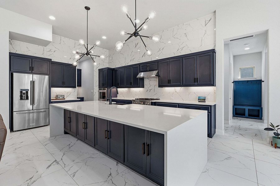 Marble-patterned tile flooring and backsplash create a luminous, clean-lined culinary space. Marble-patterned tile flooring and backsplash create a luminous, clean-lined culinary space.