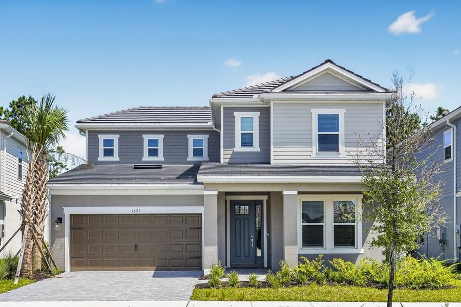 Front exterior of a new home in Hammock at Two Rivers, Zephyrhills, FL, highlighting curb appeal (Image 1). Front exterior of a new home in Hammock at Two Rivers, Zephyrhills, FL, highlighting curb appeal (Image 1).