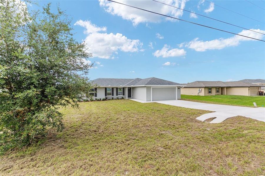 Front exterior of a new home in , Belleview, FL, highlighting curb appeal (Image 19).