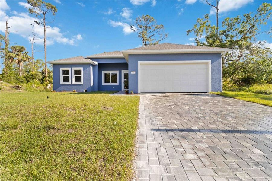 Front exterior of a new home in , North Port, FL, highlighting curb appeal (Image 1). Front exterior of a new home in , North Port, FL, highlighting curb appeal (Image 1).