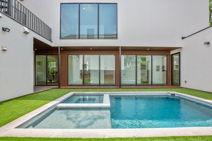 Rear view of house with a pool with connected hot tub and a patio area
