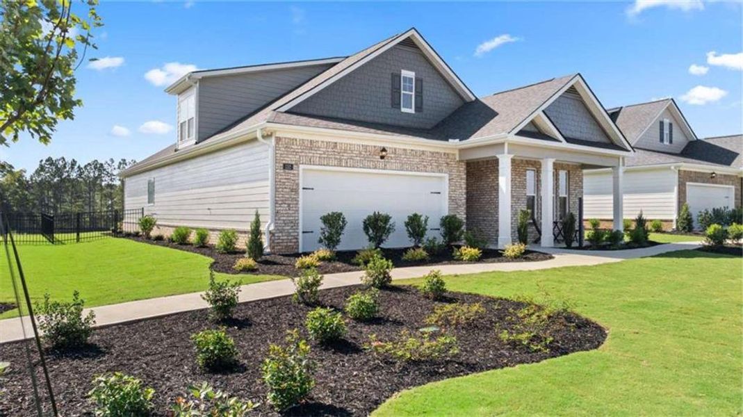 Front exterior of a new home in Oak Ridge Meadows - Active Adult, Locust Grove, GA, highlighting curb appeal (Image 22).