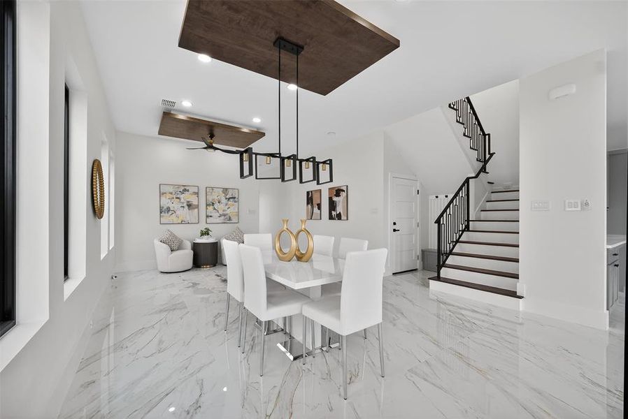 Dining room with recessed lighting, stairway, light marble finish flooring, and ceiling fan
