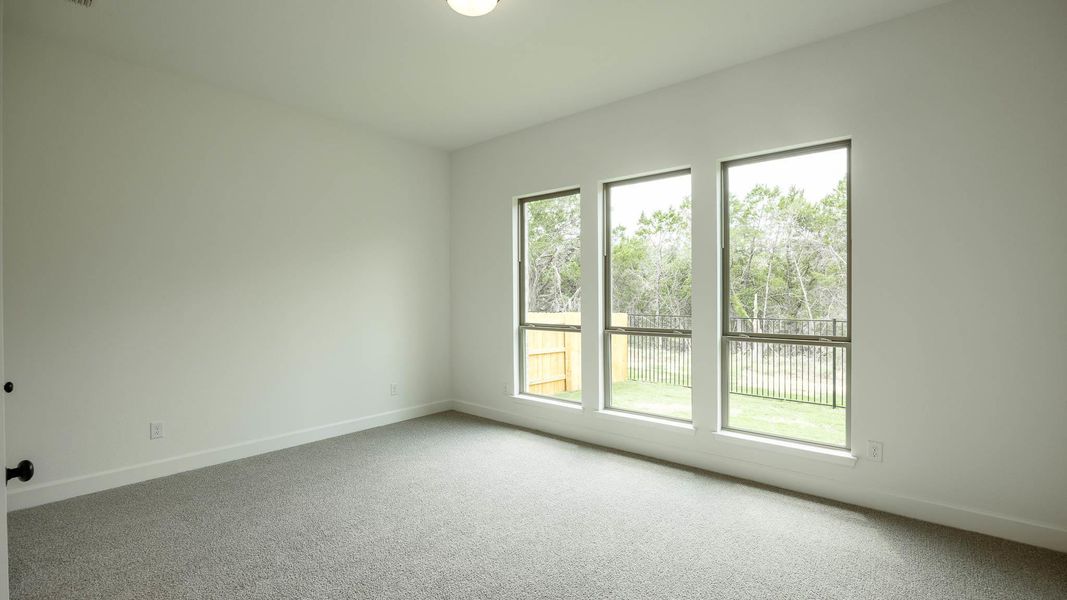 Carpeted spare room with baseboards Carpeted spare room with baseboards