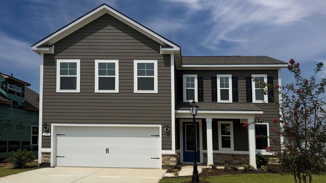 Front exterior of a new home in Brunswick Plantation, Ash, NC, highlighting curb appeal (Image 1). Front exterior of a new home in Brunswick Plantation, Ash, NC, highlighting curb appeal (Image 1).