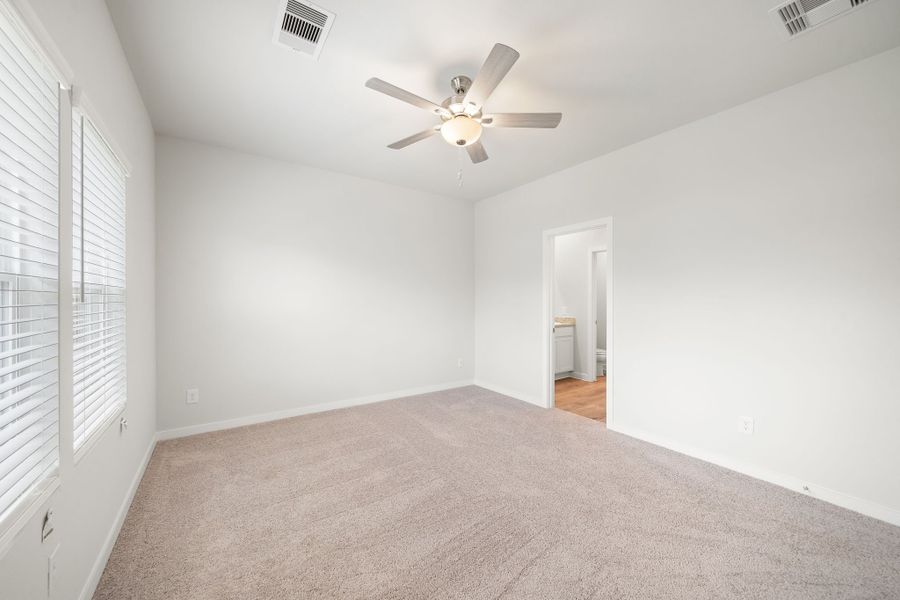 A room with a ceiling fan and a door. A room with a ceiling fan and a door.