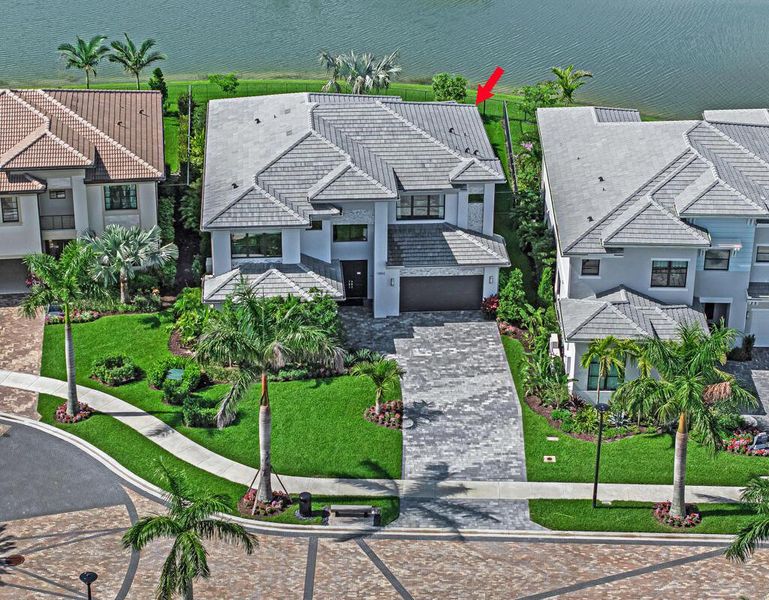 Front exterior of a new home in Apex at Avenir, Palm Beach Gardens, FL, highlighting curb appeal (Image 1).