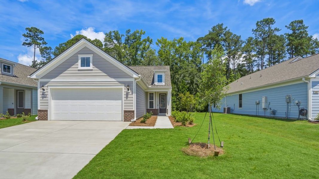 Front exterior of a new home in Sun City Hilton Head, Bluffton, SC, highlighting curb appeal (Image 24). Front exterior of a new home in Sun City Hilton Head, Bluffton, SC, highlighting curb appeal (Image 24).