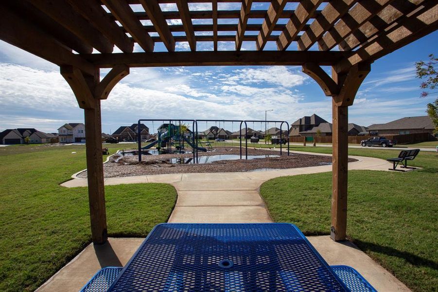 Wood pergola structure overlooking a community green space