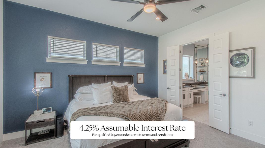 Bedroom featuring light colored carpet, ensuite bath, and ceiling fan
