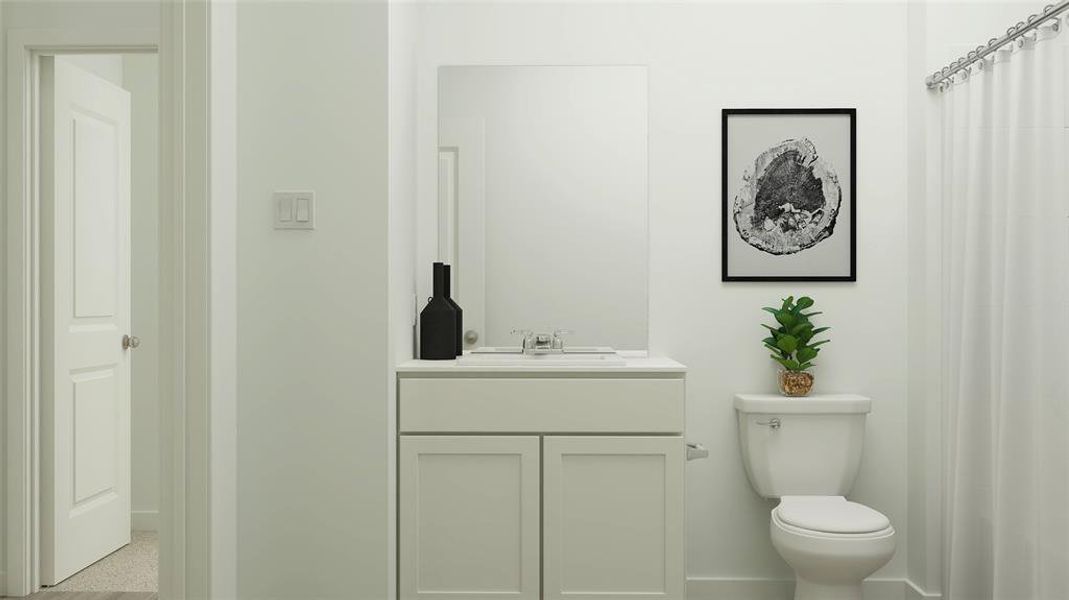 Bathroom featuring vanity and toilet