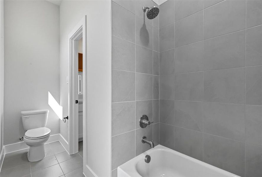 Full bath with shower / bathtub combination and tile patterned flooring Full bath with shower / bathtub combination and tile patterned flooring