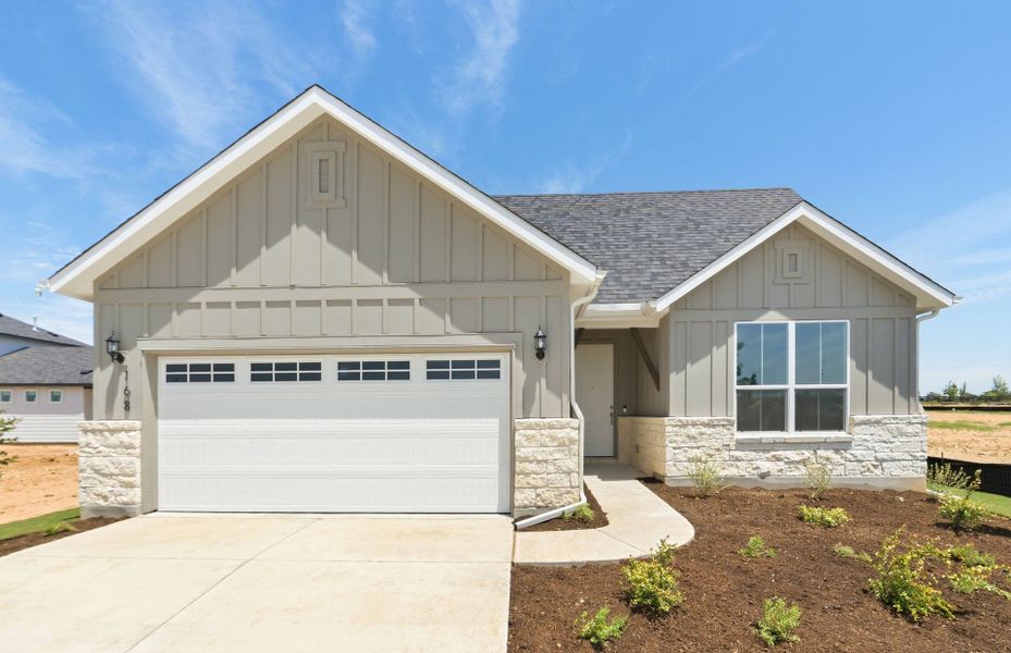 Front exterior of a new home in Del Webb Austin at Lost Pines, Bastrop, TX, highlighting curb appeal (Image 2). Front exterior of a new home in Del Webb Austin at Lost Pines, Bastrop, TX, highlighting curb appeal (Image 2).