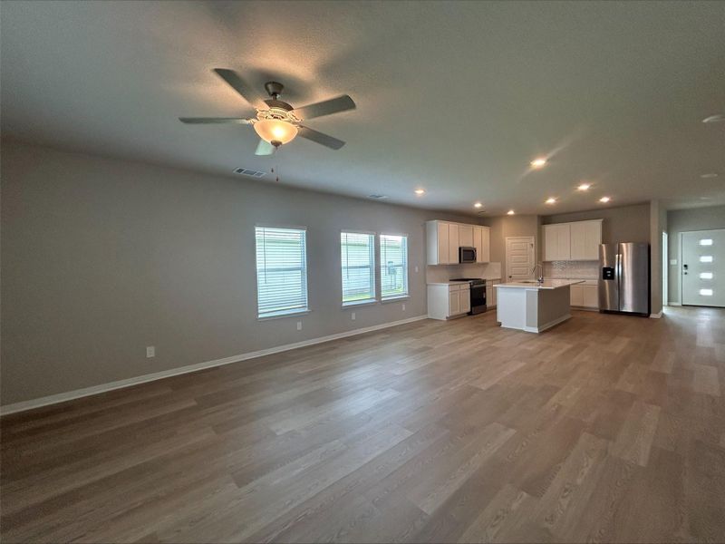 Unfurnished living room with light wood-style floors, recessed lighting, and ceiling fan Unfurnished living room with light wood-style floors, recessed lighting, and ceiling fan