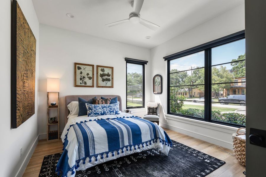 This first floor secondary bedroom #3 offers great flexibility with a french door entry, oversized front-facing windows, hardwood flooring, and a double door closet. it's layout works well as a guest suite, study, game room, or additional flex space depending on your needs.
