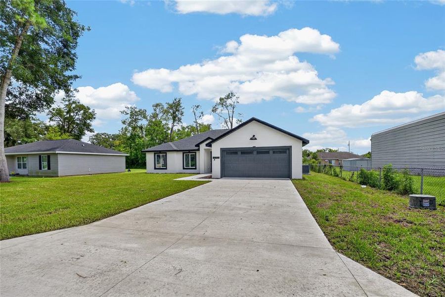 Front exterior of a new home in , Summerfield, FL, highlighting curb appeal (Image 24). Front exterior of a new home in , Summerfield, FL, highlighting curb appeal (Image 24).