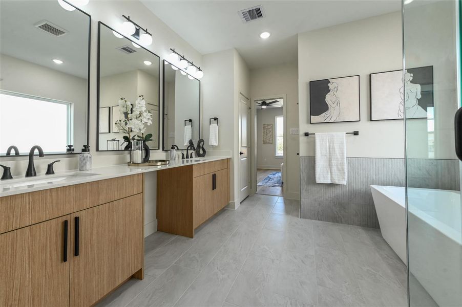 Spa primary bathroom offers double sinks, vanity area, stand alone fub & walk in shower Spa primary bathroom offers double sinks, vanity area, stand alone fub & walk in shower