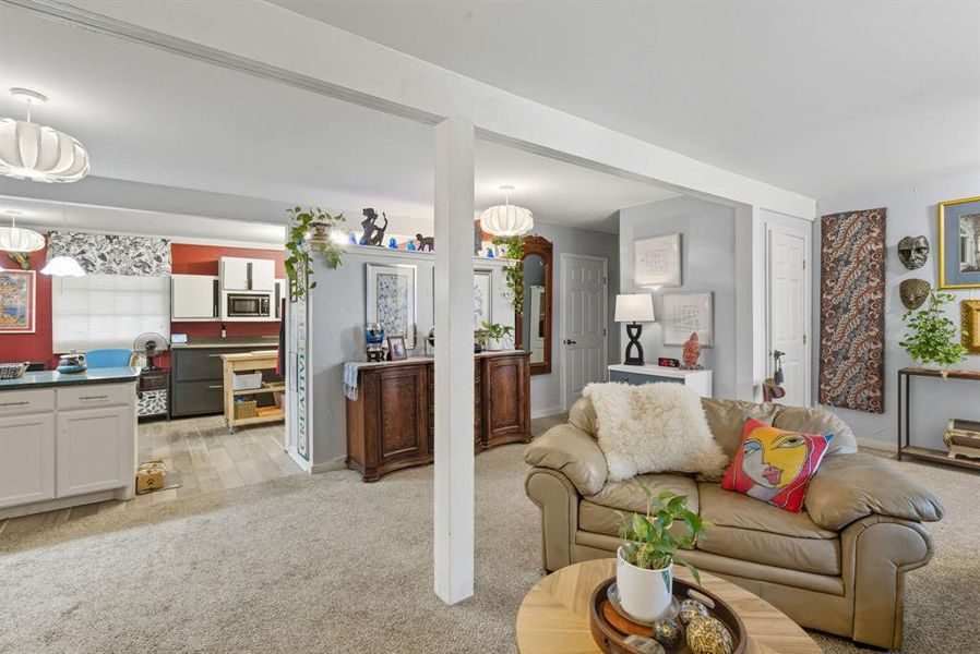 Living room with light colored carpet and baseboards Living room with light colored carpet and baseboards