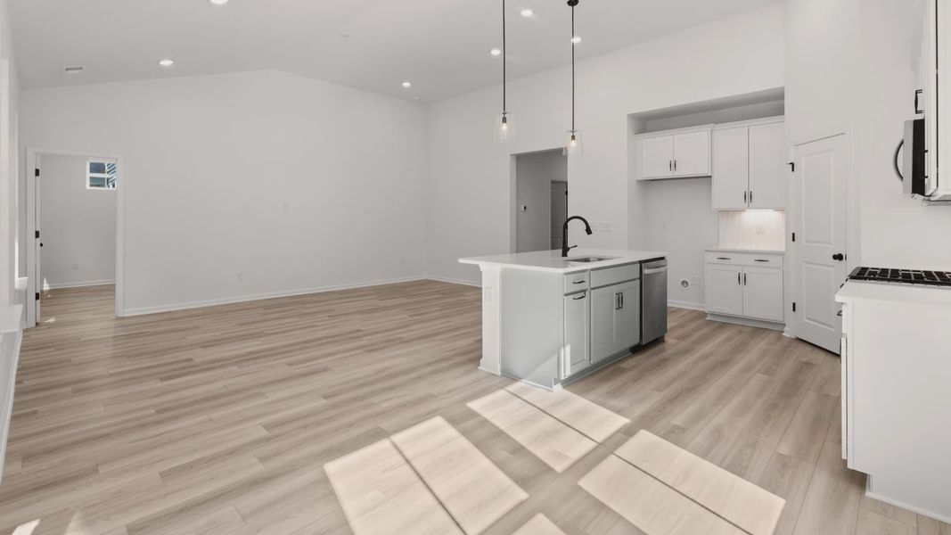 Open-concept living area with direct entry to the private primary suite