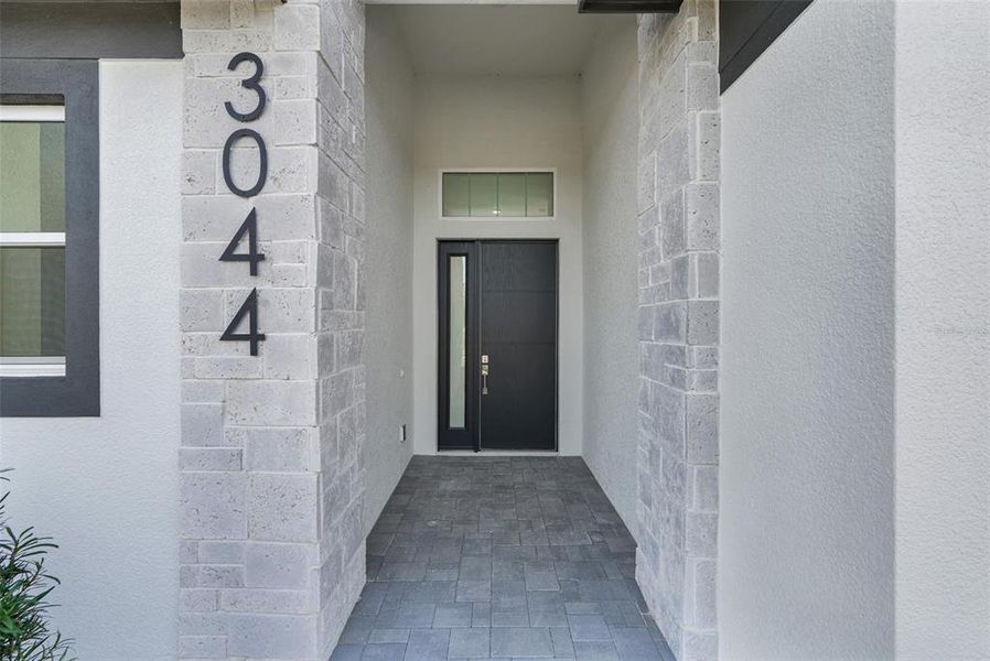 Exterior details and patio area of a home in Hampton Green at Providence, Davenport (Image 30).