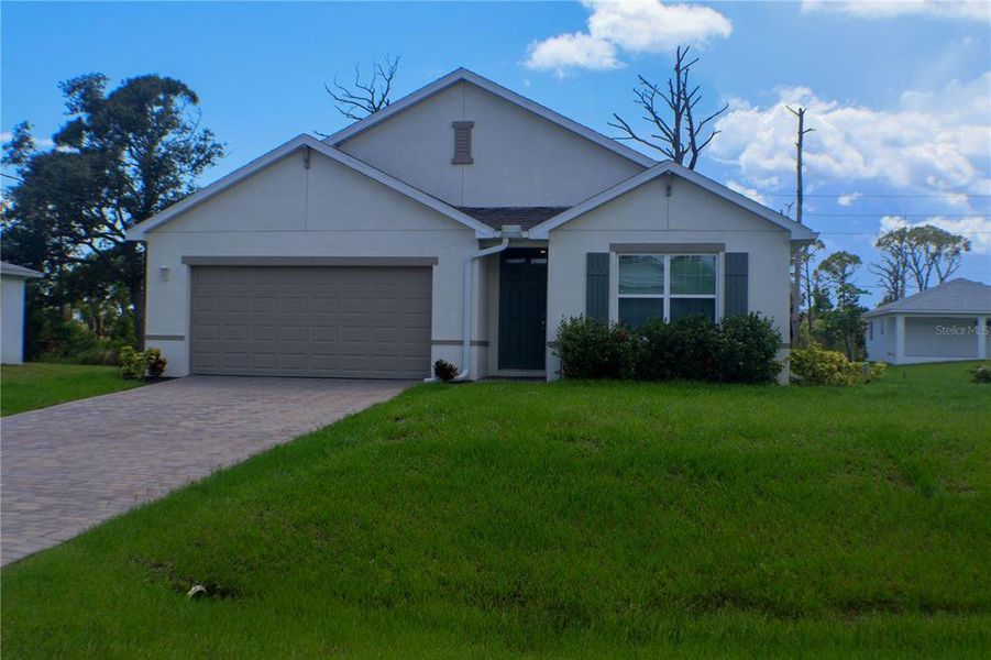 Front exterior of a new home in Gulf Cove, Port Charlotte, FL, highlighting curb appeal (Image 2). Front exterior of a new home in Gulf Cove, Port Charlotte, FL, highlighting curb appeal (Image 2).