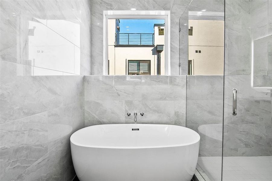 Bathroom with independent shower and bath and tile walls