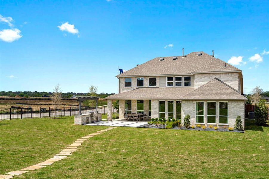 Back of house featuring a patio, central AC unit, a lawn, and a pergola