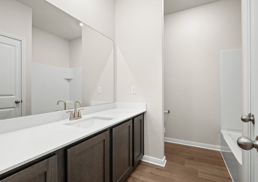The secondary bathroom has a large vanity space and a shower-tub combo. The secondary bathroom has a large vanity space and a shower-tub combo.