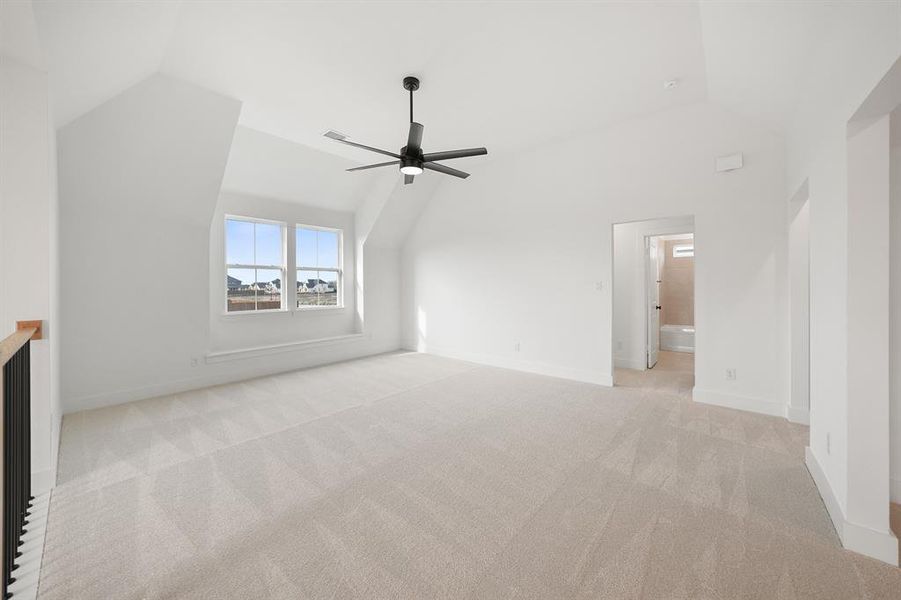 Unfurnished living room with lofted ceiling, light carpet, and ceiling fan
