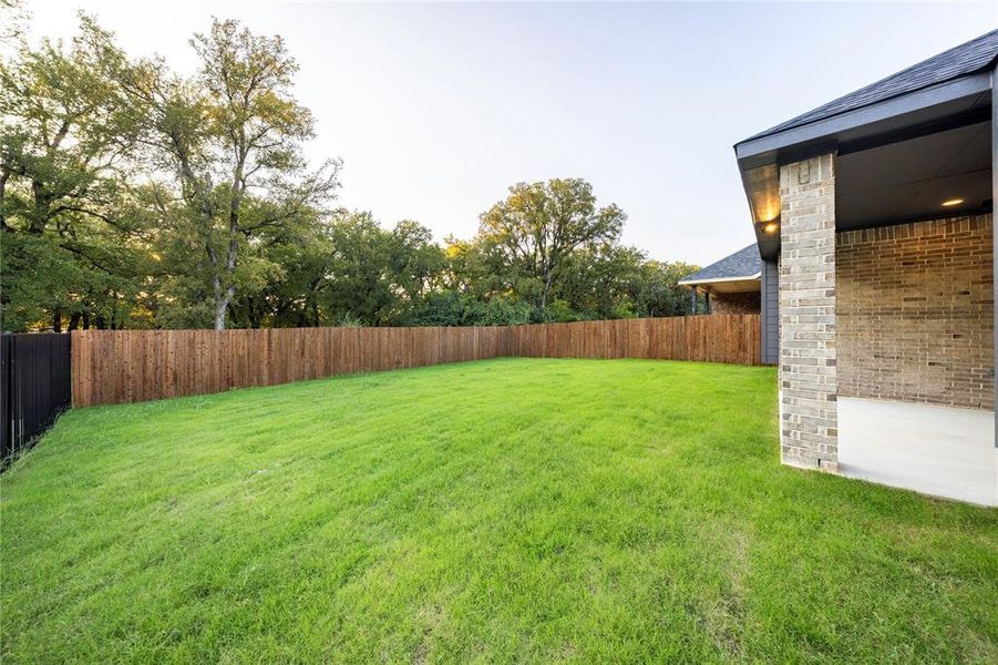 Fenced backyard featuring a patio