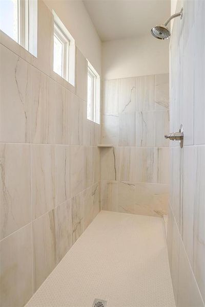 Bathroom featuring tiled shower