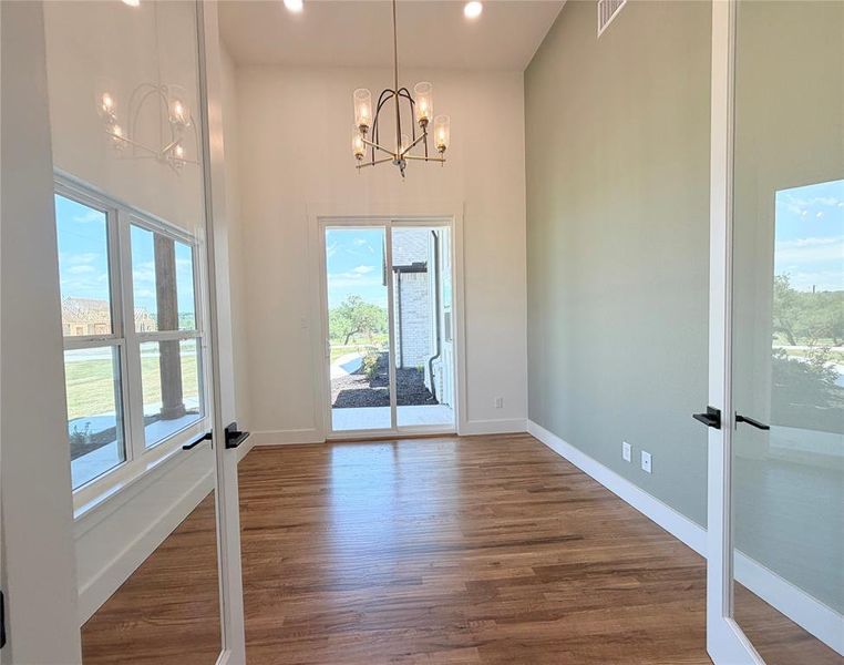 Beautiful accent wall in office. French Doors from foyer showcase this awesome room. Could be used as formal dining if needed