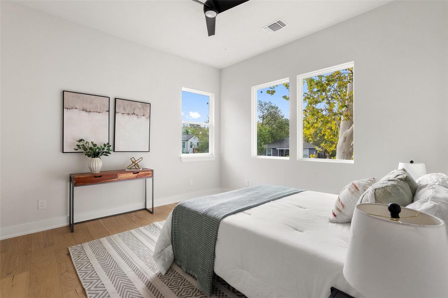 Bedroom with wood finished floors and ceiling fan Bedroom with wood finished floors and ceiling fan