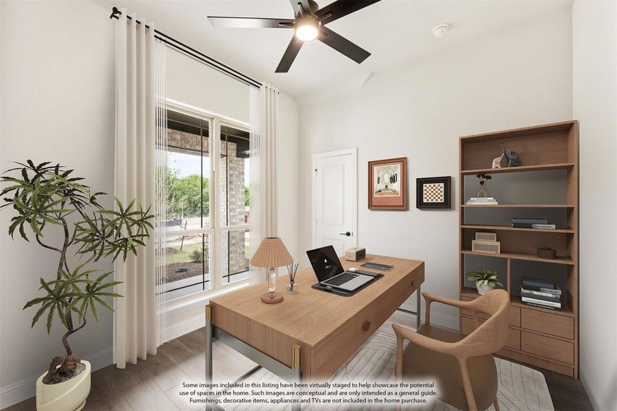 Home office with wood desk, ceiling fan, built-in shelving, and large window with sheer curtains