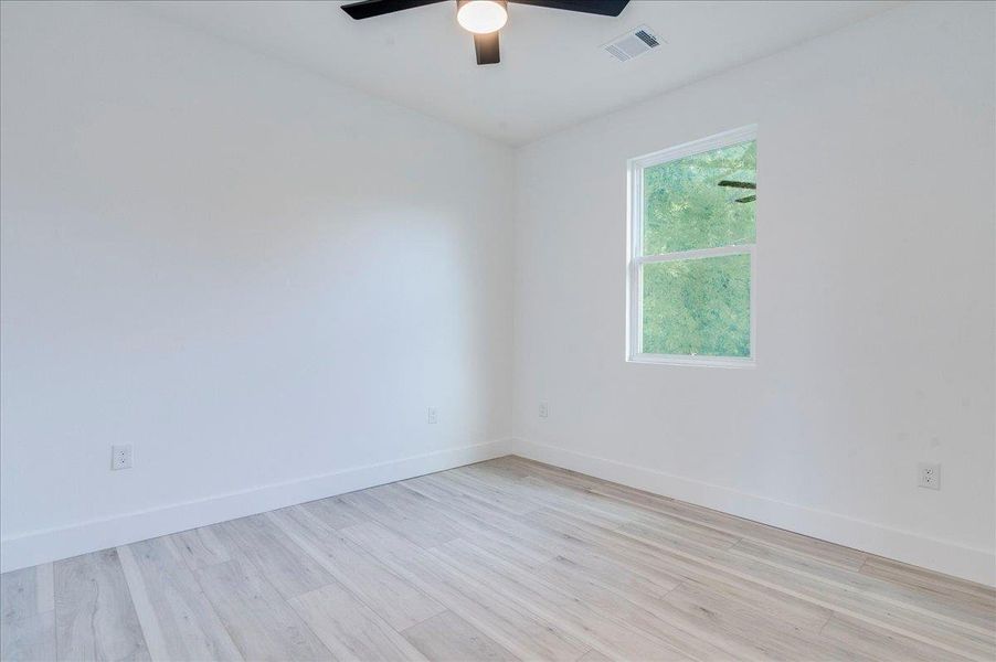 Room featuring wood finished floors and ceiling fan