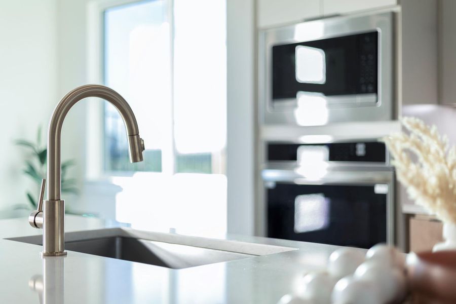 Kitchen view of stainless steel appliances and a sink