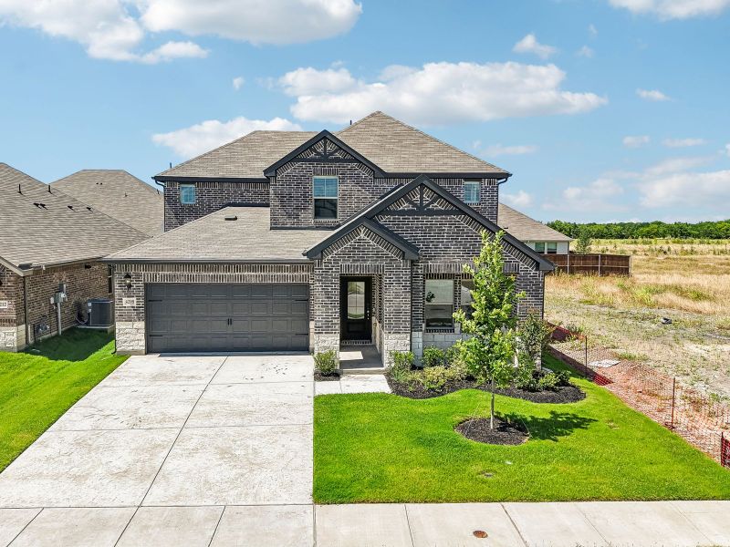 Front exterior of a new home in Lakehaven - Signature Series, Farmersville, TX, highlighting curb appeal (Image 1). Front exterior of a new home in Lakehaven - Signature Series, Farmersville, TX, highlighting curb appeal (Image 1).