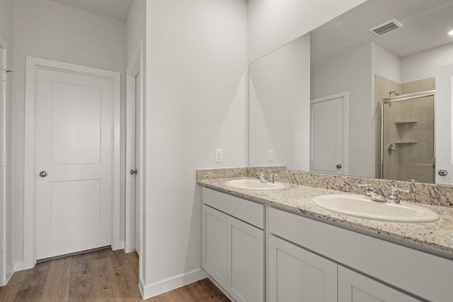 A bathroom with a large mirror.