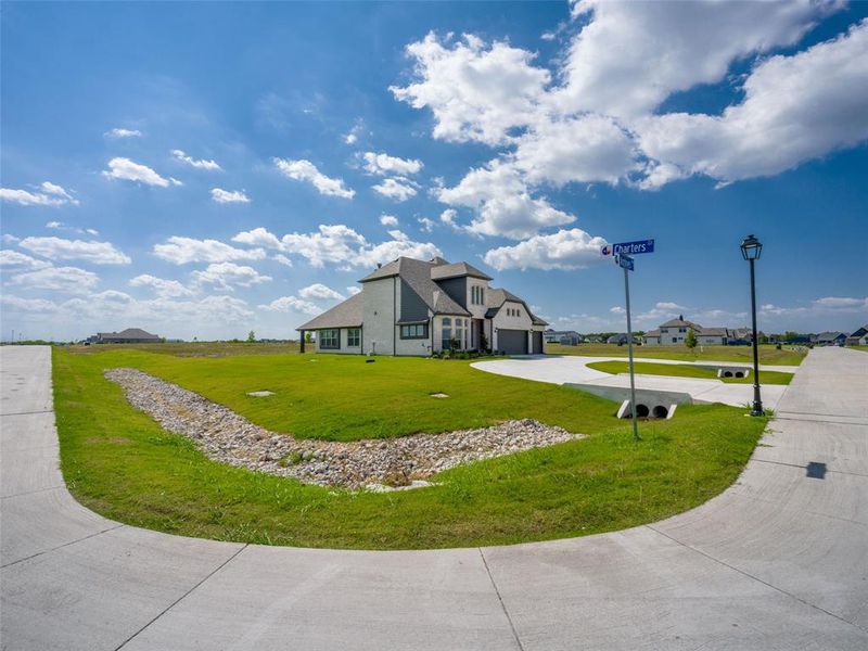 View of front of property featuring concrete driveway and a front yard View of front of property featuring concrete driveway and a front yard