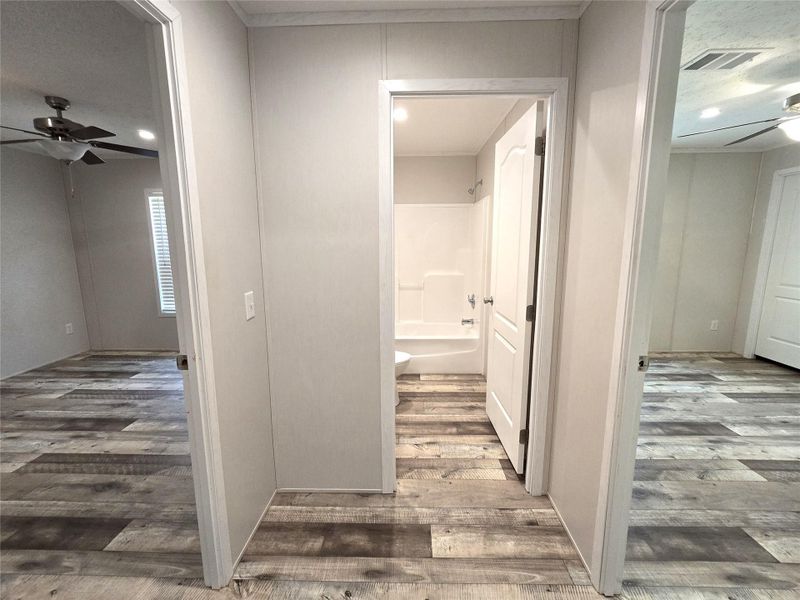 This inviting hallway, featuring stylish wood-look flooring and modern neutral tones, seamlessly connects spacious rooms, offering a warm and welcoming path through your future home. This inviting hallway, featuring stylish wood-look flooring and modern neutral tones, seamlessly connects spacious rooms, offering a warm and welcoming path through your future home.