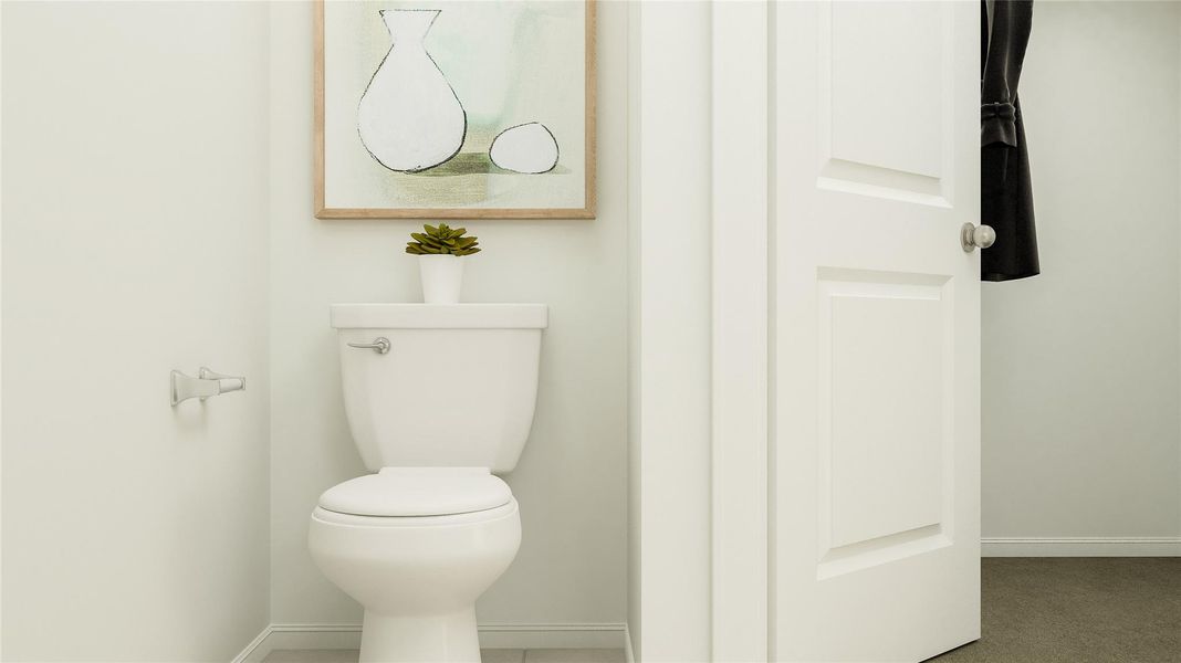 Bathroom featuring toilet and baseboards Bathroom featuring toilet and baseboards