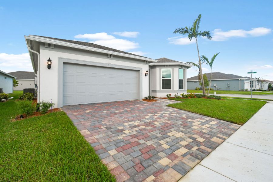 Front exterior of a new home in Del Webb Tradition, Port St. Lucie, FL, highlighting curb appeal (Image 20).