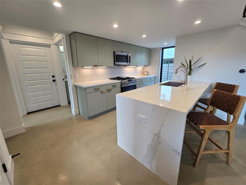 Kitchen with the waterfall island effect on the beautiful Toscana Cream Silestone countertop.