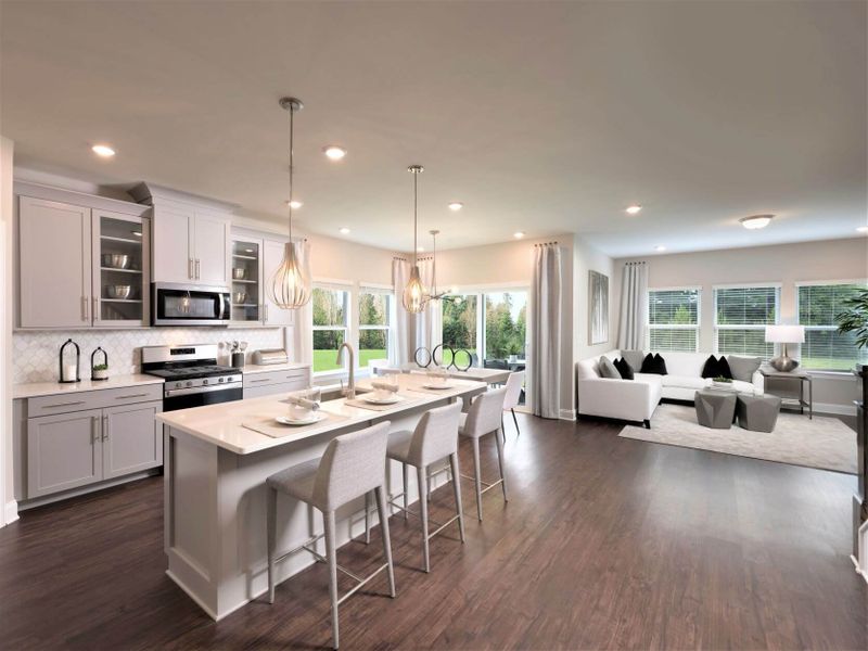 The open-concept floorplan connects the kitchen to the dining and living areas.