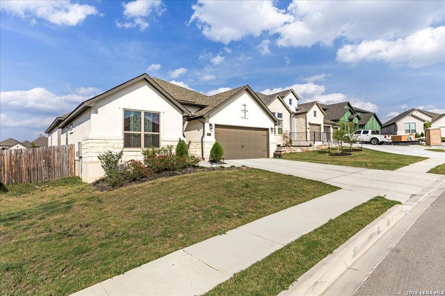 Front exterior of a new home in , Bulverde, TX, highlighting curb appeal (Image 22).