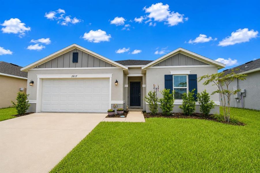 Front exterior of a new home in , Haines City, FL, highlighting curb appeal (Image 2). Front exterior of a new home in , Haines City, FL, highlighting curb appeal (Image 2).