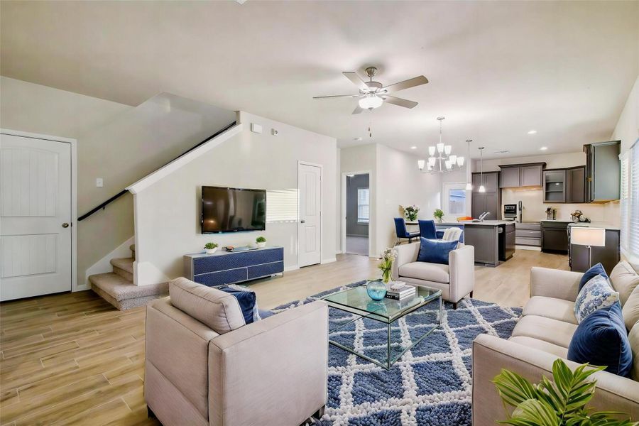 Notice the seamless blend in between rooms, and the gorgeous wood-look flooring that flows throughout the home.