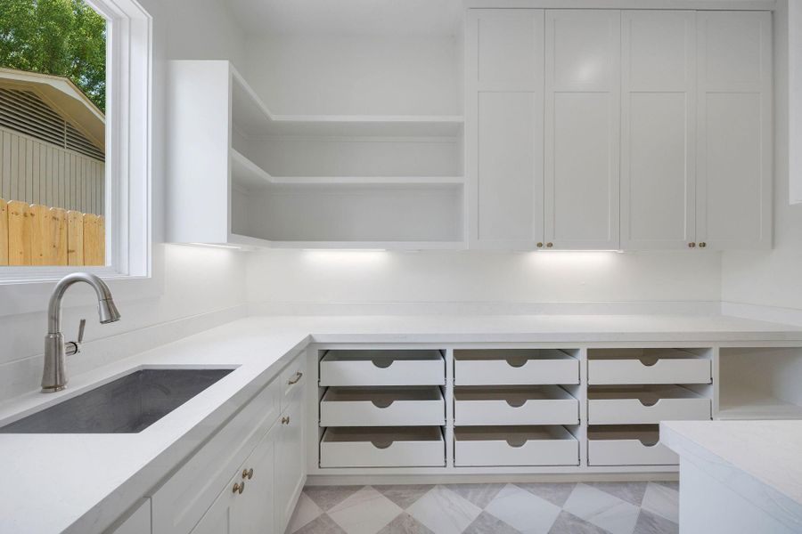 Ideally located and perfectly sized, this scullery/prep kitchen combines thoughtful pantry space with a second sink. Ideally located and perfectly sized, this scullery/prep kitchen combines thoughtful pantry space with a second sink.