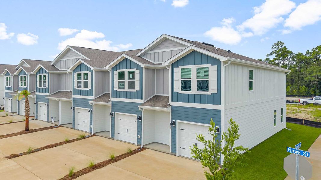 Front exterior of a new home in Hawks Landing Townhomes, Santa Rosa Beach, FL, highlighting curb appeal (Image 1).