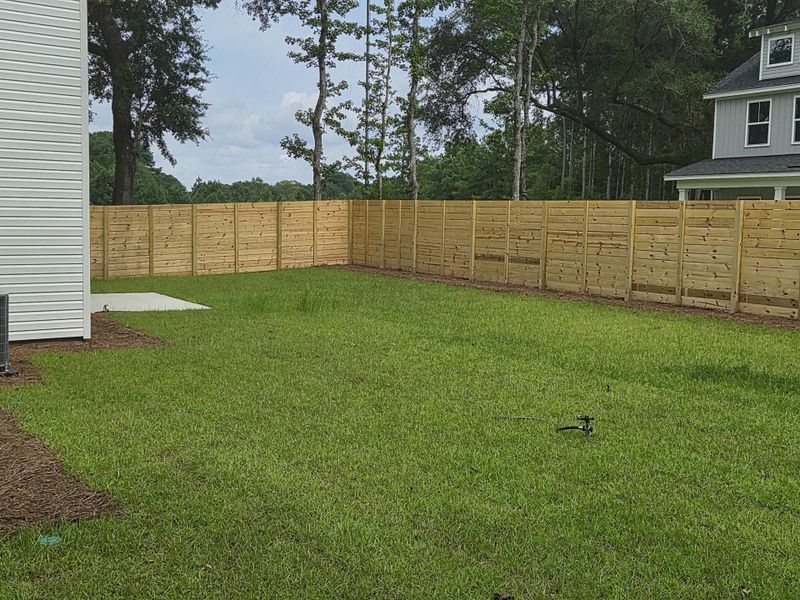 Front exterior of a new home in , Awendaw, SC, highlighting curb appeal (Image 1).
